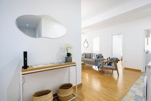 A modern living room with a sofa, a coffee table, and a dining area with a counter and baskets. - CENTRAL APARTMENT, 12 MIN. AWAY FROM THE BEACH, (Almeria)