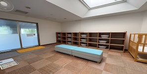A room with a skylight, a bench, and shelves with baskets.