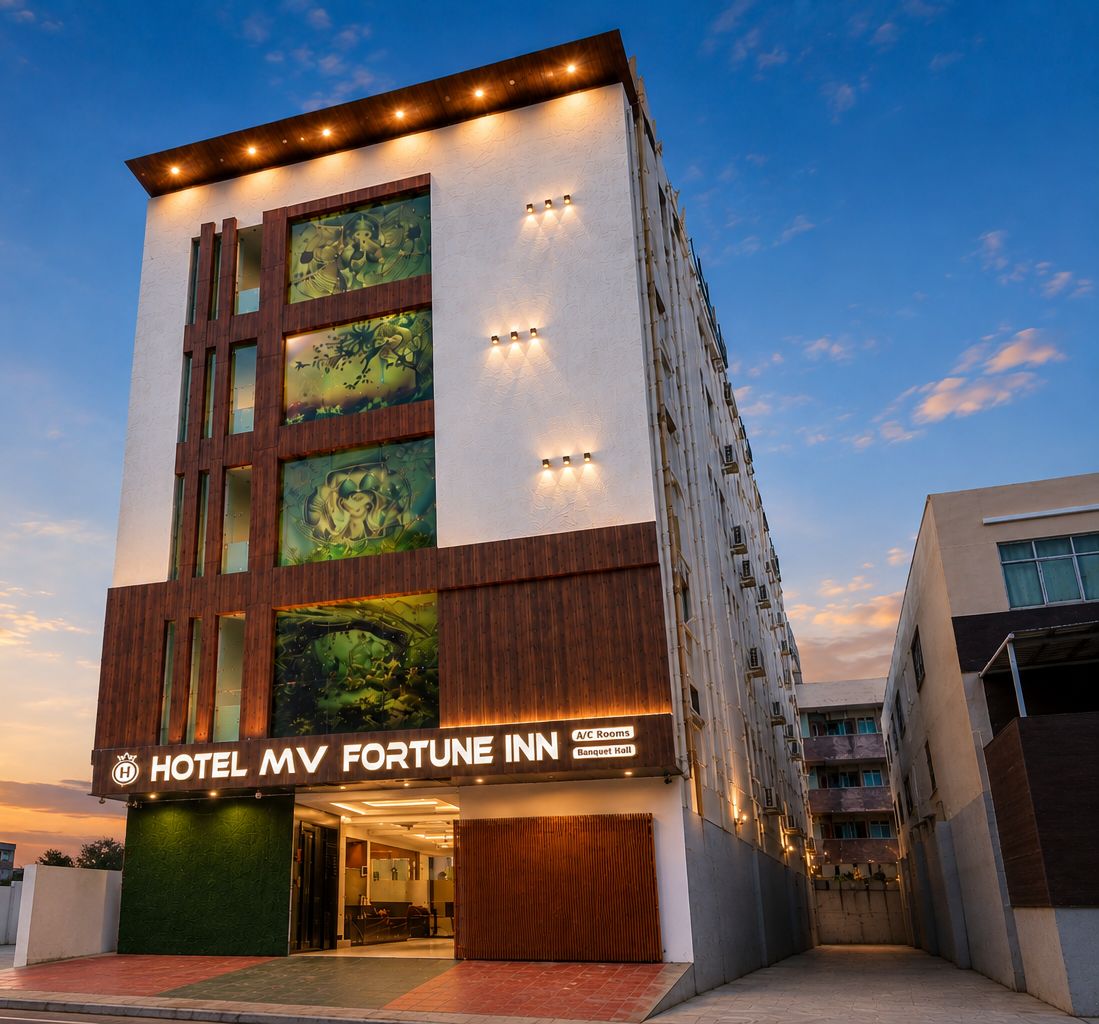 A multi-story hotel with a modern facade, including a prominent sign for the Hotel MV Fortune Inn.