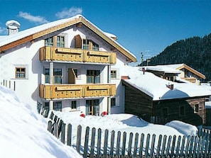 A multi-story building with balconies, surrounded by snow. - Appartements Lärchenhof, (Samnaun-Compatsch) by Interhome (Samnaun)