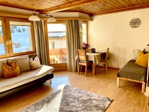 A cozy room with a sofa, a small table, and a bed. - Apart Kleinstein-Maass Nr. 1, (Samnaun-Plan) by Interhome (Samnaun)