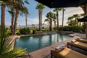 A pool area with lounge chairs and a view of a golf course and mountains. - Canyon House at PGA West | Poolside Golf Views (La Quinta)
