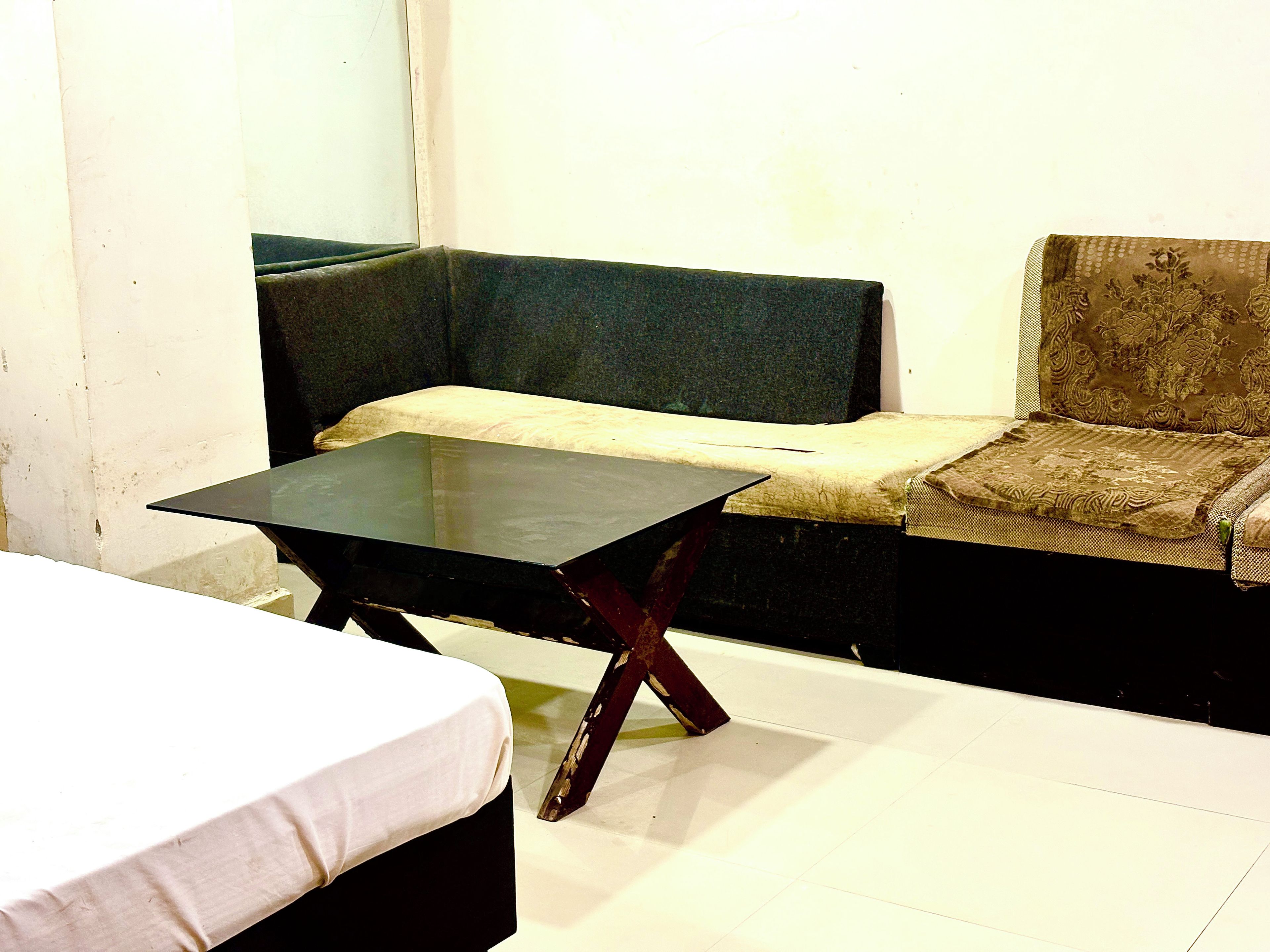 A room with a bed, a table, and a sofa.