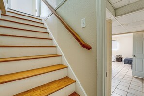 A staircase with wooden steps and a handrail, leading to an open doorway. - Kennesaw Home Near KSU & Lake Acworth (Kennesaw)