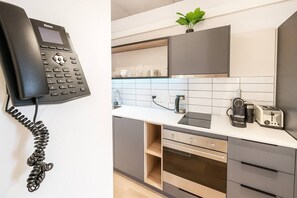 A modern kitchen with a built-in phone, a coffee maker, and a toaster. - Room-oceanfront Bliss With Breathtaking (Cape Town)