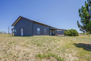 A large, single-story building with a flat roof and a covered outdoor area. - Countryside Home Right Outside Fort Worth (Joshua)