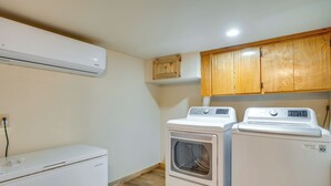 A laundry room with two white washing machines, a dryer, and a wooden cabinet above. - Yuba River Retreat for 2! Near Swimming Holes (Washington)