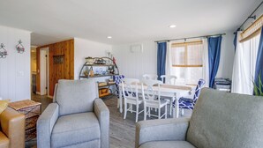 A cozy living area with a dining table, chairs, and a sofa. - Direct Beach Access, 2 Mi to Chinook Winds Casino (Lincoln City)