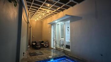 A swimming pool with a tiled floor and a ceiling with a grid pattern.