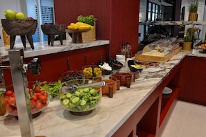 A buffet with various food items and condiments.