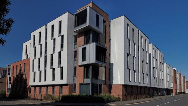 A multi-story building with a modern architectural design, featuring a mix of brick and white facades, and a series of windows on each floor. - Student Only Apollo Works (Coventry)