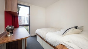 A bedroom with a bed, a desk, and a window. - Student Only Apollo Works (Coventry)