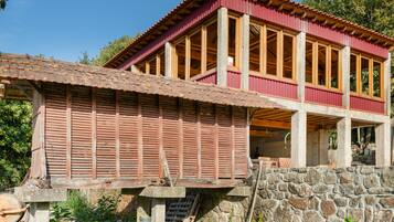 A two-story building with a red exterior and wooden beams.