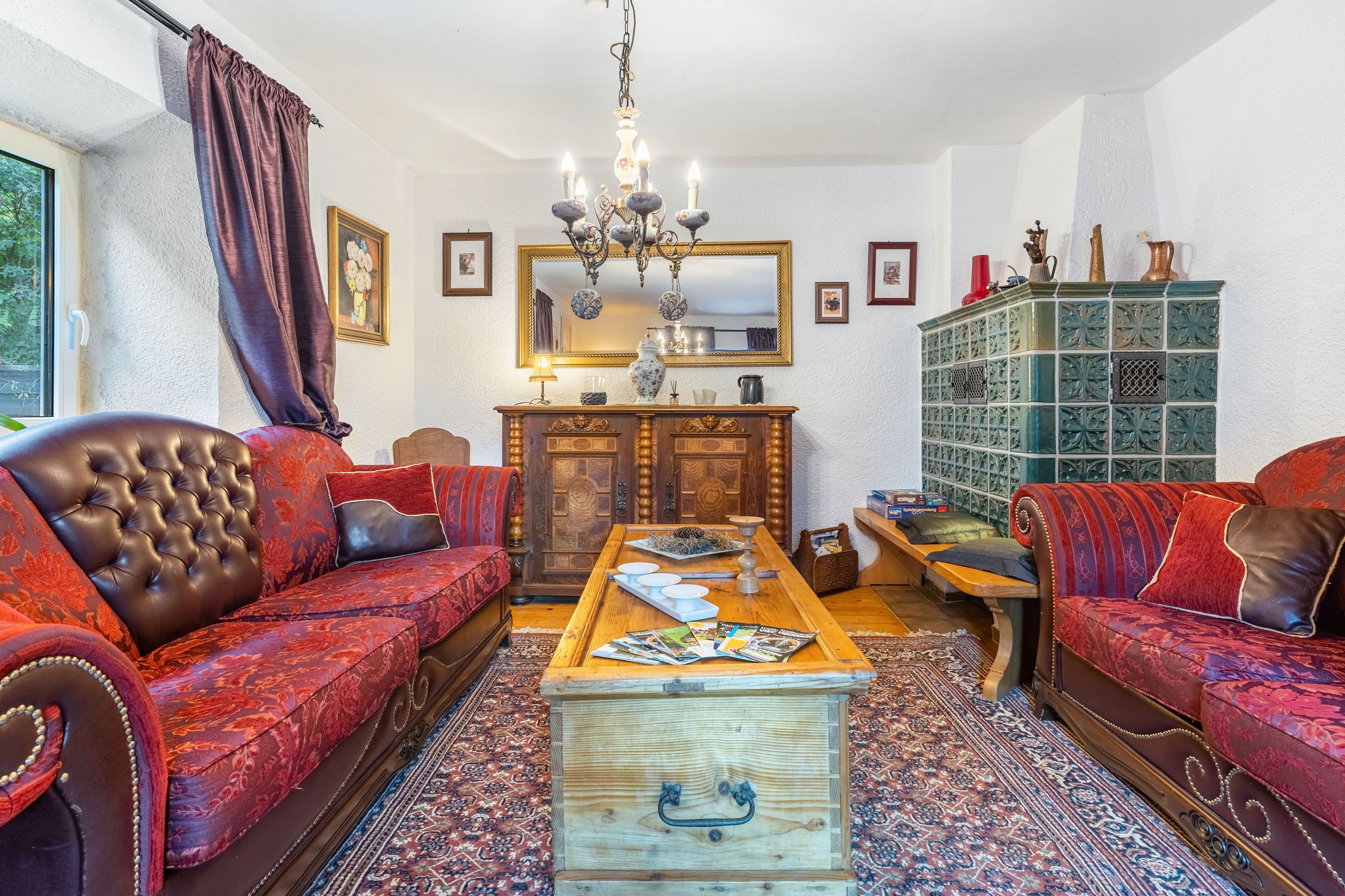 A traditional living room with a sofa set, a wooden coffee table, and a cabinet.