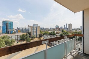 A balcony with a view of a cityscape, including various buildings and a clear sky. - New! 2BR Flat w/Balcony & Views in Popular (Greater London)
