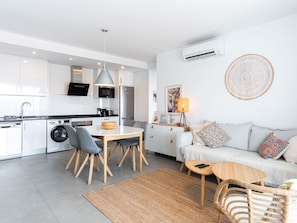 A modern apartment with a kitchen, dining area, and living room. - Balcon del Mar Seaview 211 by Casasol by Interhome (Nerja)