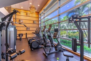 A gym with cardio machines, weight equipment, and large windows offering a view of greenery. - New Listing! Upscale 3 Bedroom townhome in Little Harbor Resort, 2 onsite Restaurants | Heated Pools (Ruskin)