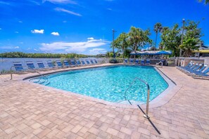 A swimming pool with lounge chairs and a view of the water. - New Listing! Upscale 3 Bedroom townhome in Little Harbor Resort, 2 onsite Restaurants | Heated Pools (Ruskin)