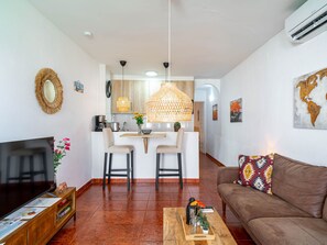 A modern living room with a brown sofa, a wooden coffee table, and a TV on a wooden stand. - Arce 5 Torrecilla Beach by Casasol by Interhome (Nerja)