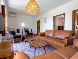 A living room with a sofa, chairs, a coffee table, and a hanging light fixture. - Villa Lorca Vista Mar by Casasol by Interhome (Nerja)