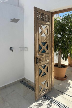 A wooden door with a geometric pattern, a metal handle, and a small window. - Villa La Casita Fuente del Baden 52 by Casasol by Interhome (Nerja)