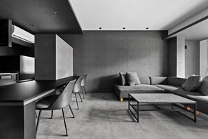 A modern interior with a dining area, sofa, and coffee table. - HT-I (Asahikawa)