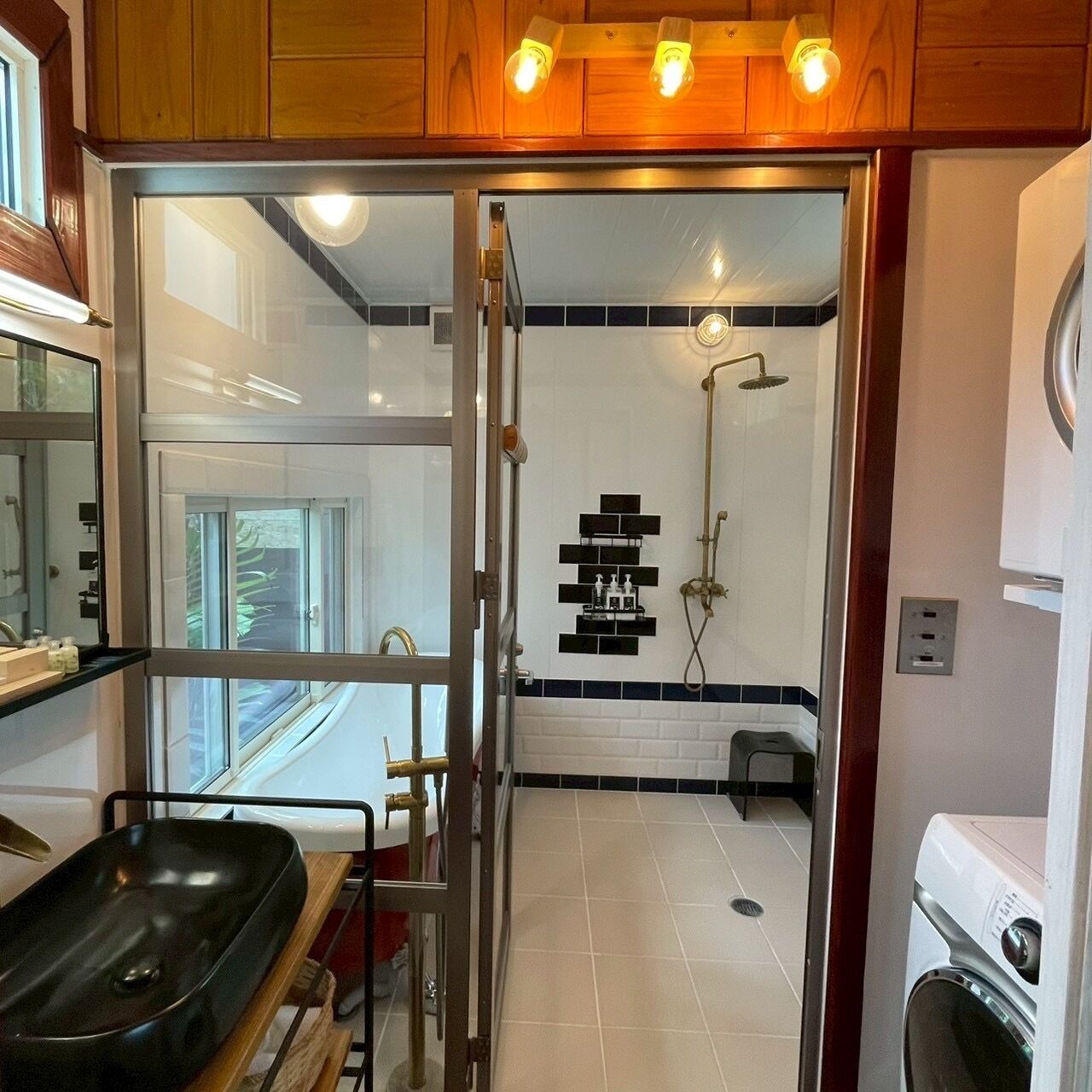 A modern bathroom with a glass shower enclosure, a sink, and a toilet.