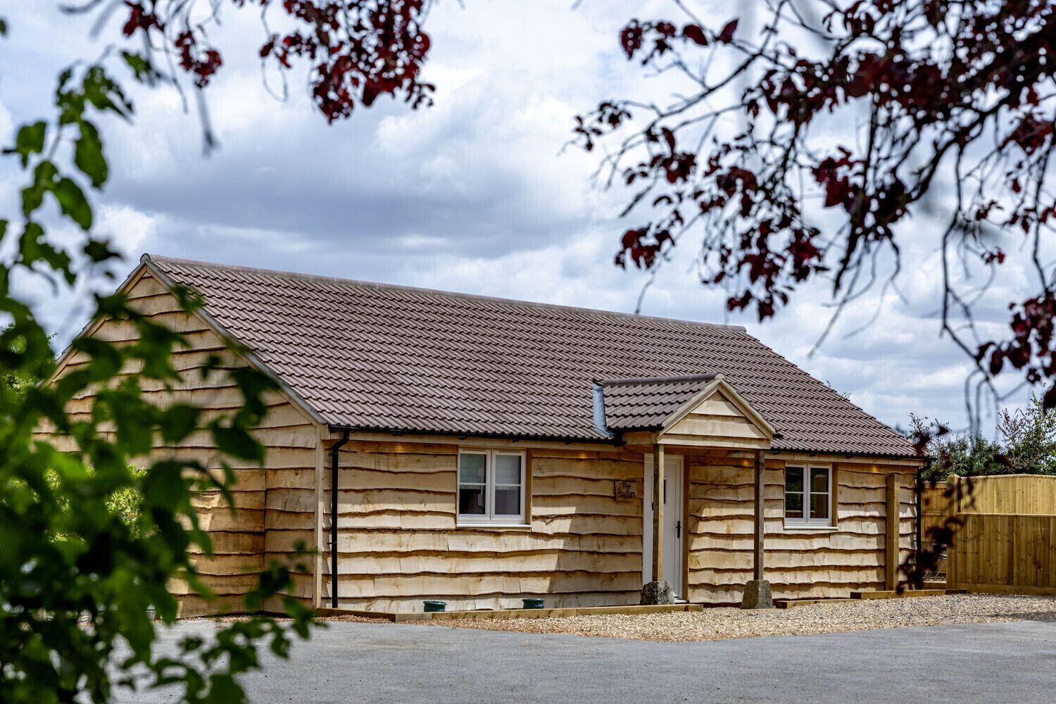 A single-story log cabin with a pitched roof, a front door, and two windows.