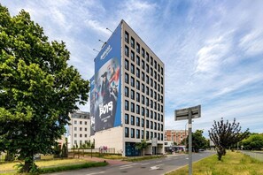 A multi-story building with a large billboard advertising 'The Boys' movie. - Old Town Heart - National Stadium Tower 47 (Warsaw)