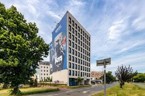 A multi-story building with a large billboard advertising 'The Boys' movie. - Old Town Heart - National Stadium Tower 22 (Warsaw)