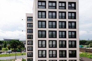 Ein mehrgeschossiges Gebäude mit einheitlicher Fassade, großen Fenstern und Balkonen.