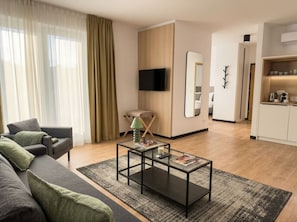 A modern living room with a sofa, coffee table, and a television. - Old Town Heart VI - Metro 100m - Stadion Narodowy (Warsaw)