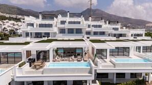 A modern residential complex with multiple white buildings, rooftop pools, and a mountainous backdrop. - Moana 4 - Luxury Home with Private Pool (Benalmádena)
