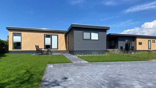 A modern two-story house with a paved driveway and a grassy lawn. - Vakantiepark de Zeeuwse Parel - de Schelde by Interhome (Scherpenisse)