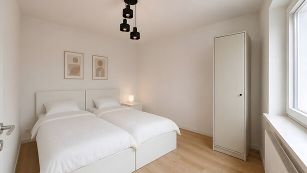 A bedroom with two beds, a wardrobe, a bedside table with a lamp, and a ceiling light fixture.