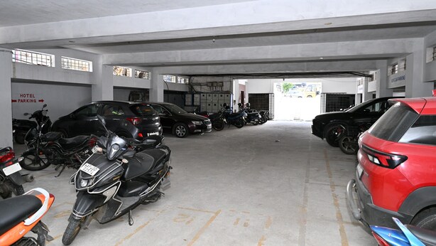 Un aparcamiento de varios niveles con diferentes vehículos, incluyendo coches y motocicletas.