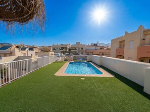 A rooftop swimming pool with a clear view of the surrounding buildings and a bright sun in the sky. - Medina Torrecilla Beach by Casasol by Interhome (Nerja)