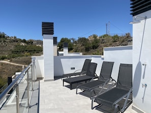 A rooftop terrace with outdoor seating and a clear view of the surrounding landscape. - Penthouse Balcon del Mar Deluxe 3 by Casasol by Interhome (Nerja)