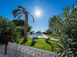 A pool area with a clear sky, palm trees, and a white fence. - Carabeo 45 Studio by Casasol by Interhome (Nerja)