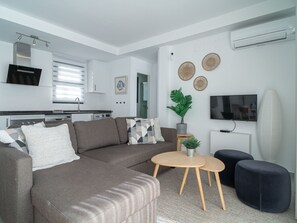 A modern living room with a sectional sofa, a coffee table, and a TV. - Penthouse Balcon del Mar 123 by Casasol by Interhome (Nerja)