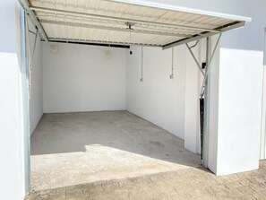 Eine Garage mit Betonboden und einer weißen Tür.