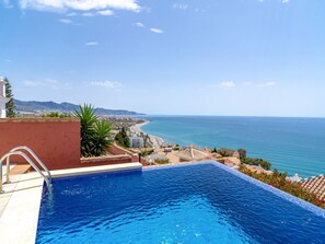 A swimming pool with a view of the sea and a coastal town. - Villa Prime Seaview by Casasol by Interhome (Nerja)