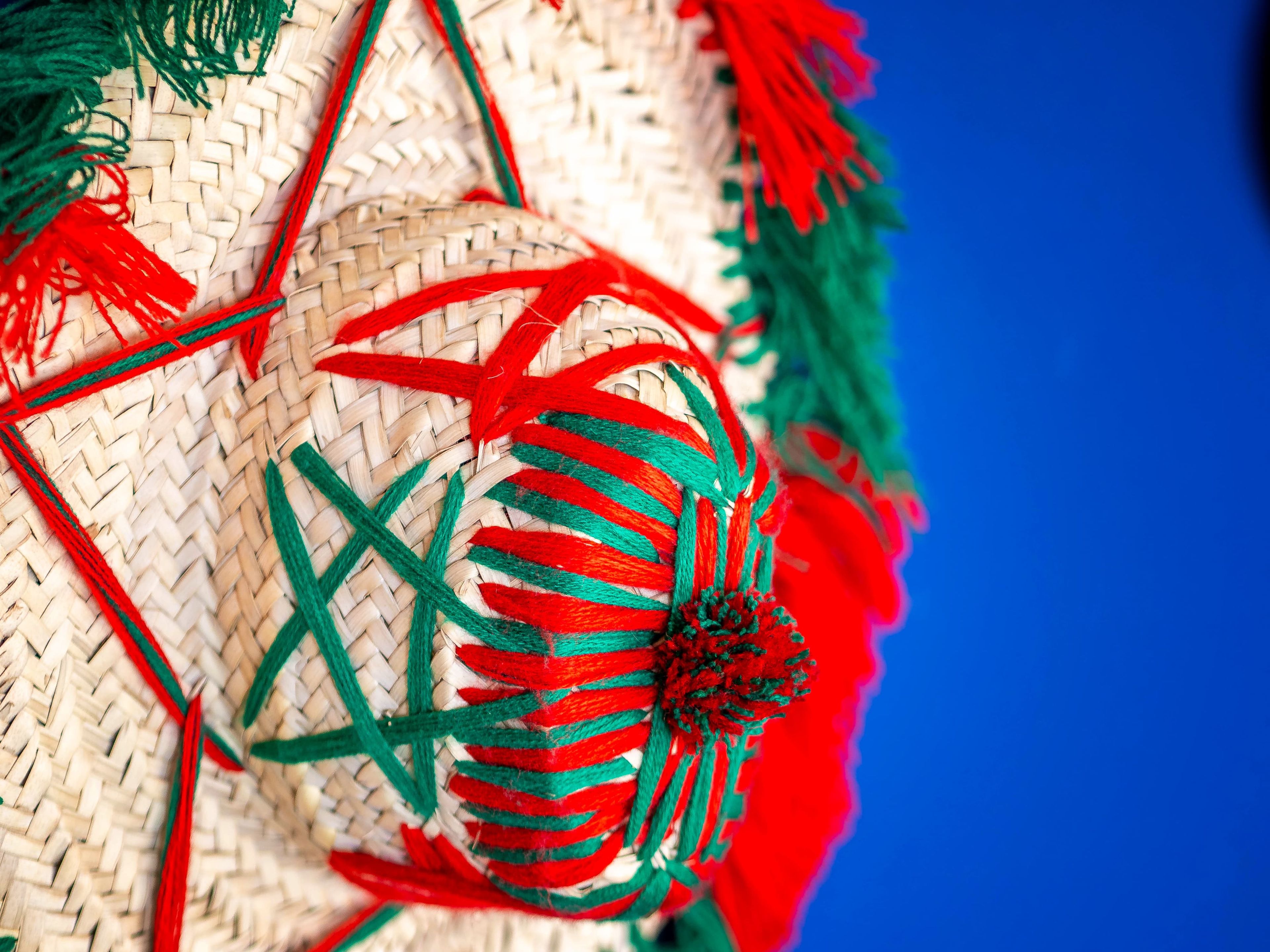 A close-up of a woven basket with red and green decorative elements.