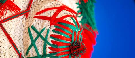 A close-up of a woven basket with red and green decorative elements.
