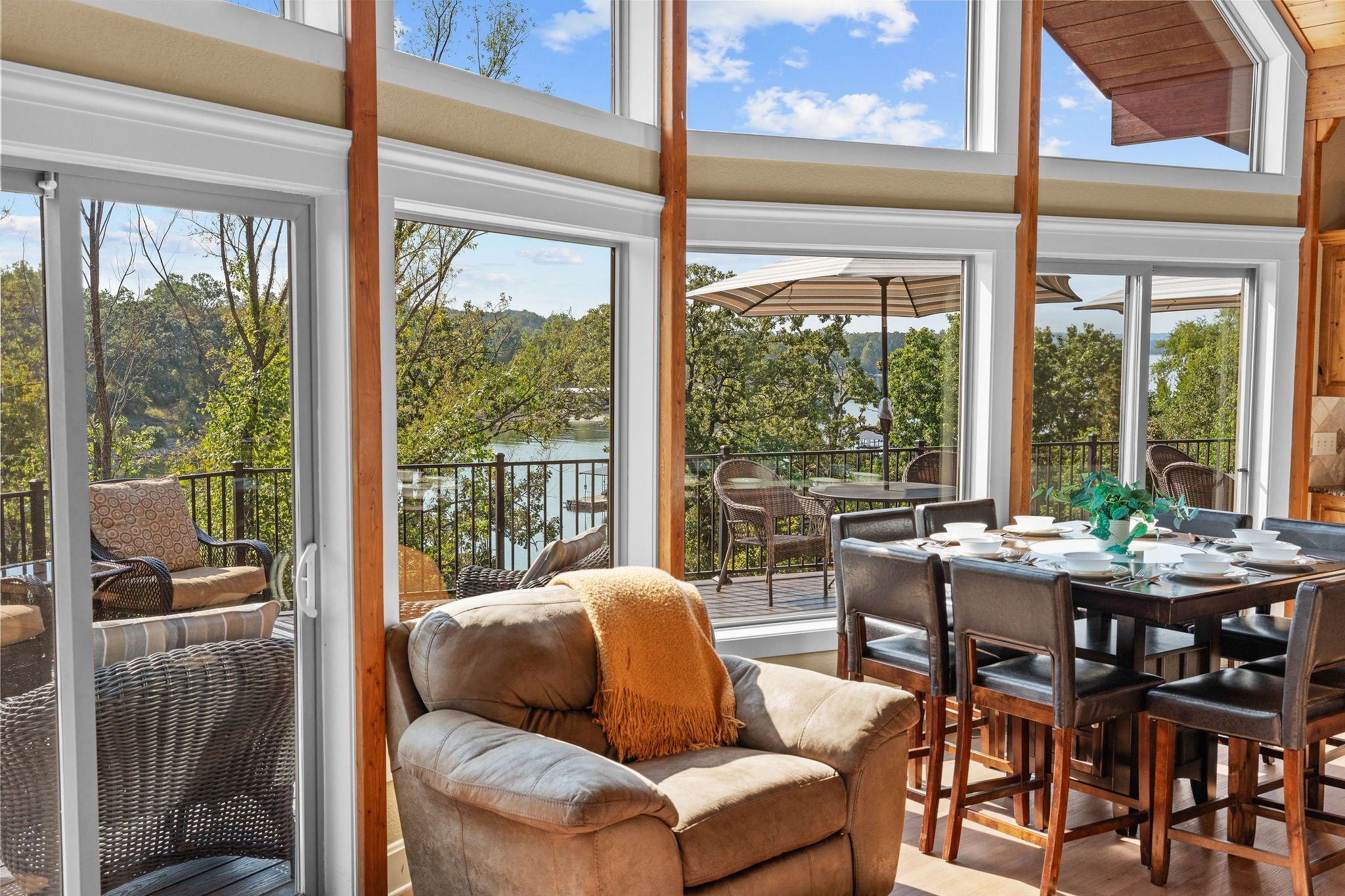 An open-plan living area with a dining table, chairs, and a sofa.