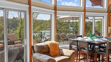 An open-plan living area with a dining table, chairs, and a sofa.