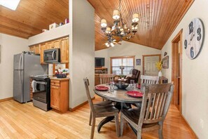 A kitchen with wooden cabinets, a refrigerator, an oven, and a microwave. - "Falling Leaf" Lodge - Stonebridge Resort by SDC- Free Daily Attraction Tickets (Branson West)
