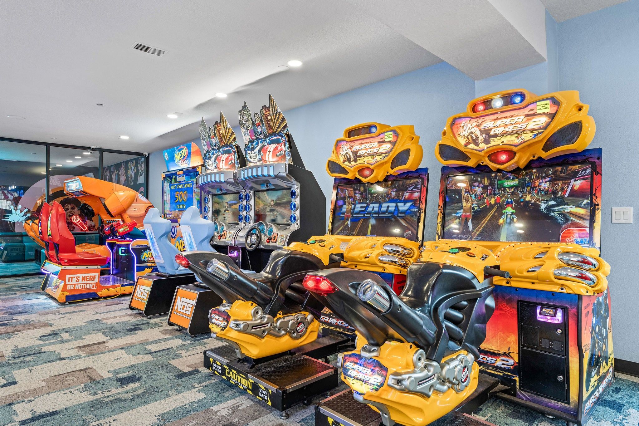 A row of arcade games including a 'Super Smash Bros. 2' machine, a 'Ninja Gaiden' game, and a 'Ninja Gaiden' arcade.