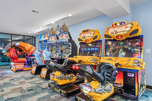 A row of arcade games including a 'Super Smash Bros. 2' machine, a 'Ninja Gaiden' game, and a 'Ninja Gaiden' arcade. - Genuine Log Cabin_Soaker Tub_Gas Fireplace_Great Location_Free Daily Attraction Tickets (Branson)