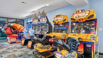 A row of arcade games including a 'Super Smash Bros. 2' machine, a 'Ninja Gaiden' game, and a 'Ninja Gaiden' arcade.